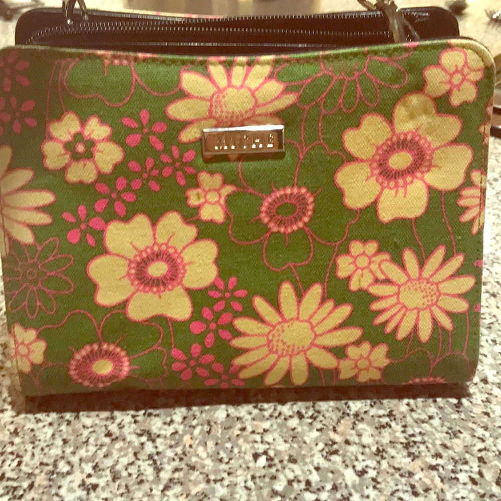 Niche purse with straps and floral shell.